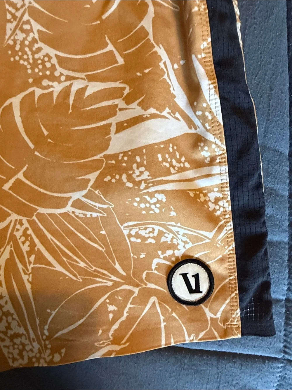 Vuori Board Swim Shorts (Black with light brown floral patterns)